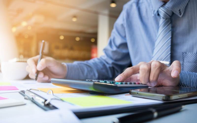 business-finance-man-calculating-budget-numbers-invoices-financial-adviser-working-min